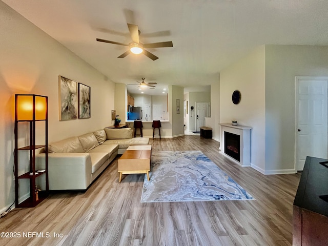 12301 Kernan Forest Blvd Unit 1905, Jacksonville, FL 32225 - living area featuring wood finished floors, a ceiling fan, baseboards, and a fireplace