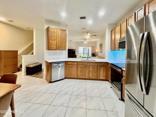 12301 Kernan Forest Blvd Unit 1905, Jacksonville, FL 32225 - kitchen featuring appliances with stainless steel finishes, a sink, light marble finish floors, ceiling fan, and tasteful backsplash