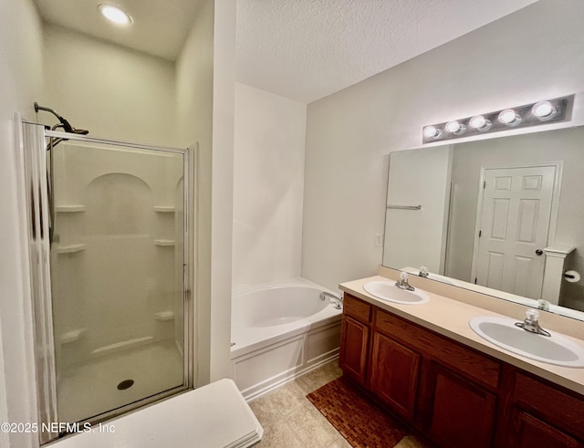 12301 Kernan Forest Blvd Unit 1905, Jacksonville, FL 32225 - full bath featuring a shower stall, double vanity, a garden tub, tile patterned flooring, and a textured ceiling