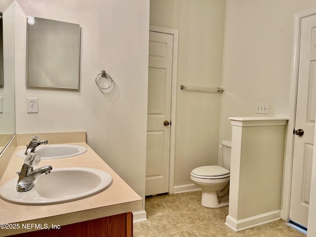 12301 Kernan Forest Blvd Unit 1905, Jacksonville, FL 32225 - bathroom featuring double vanity, toilet, tile patterned floors, and baseboards