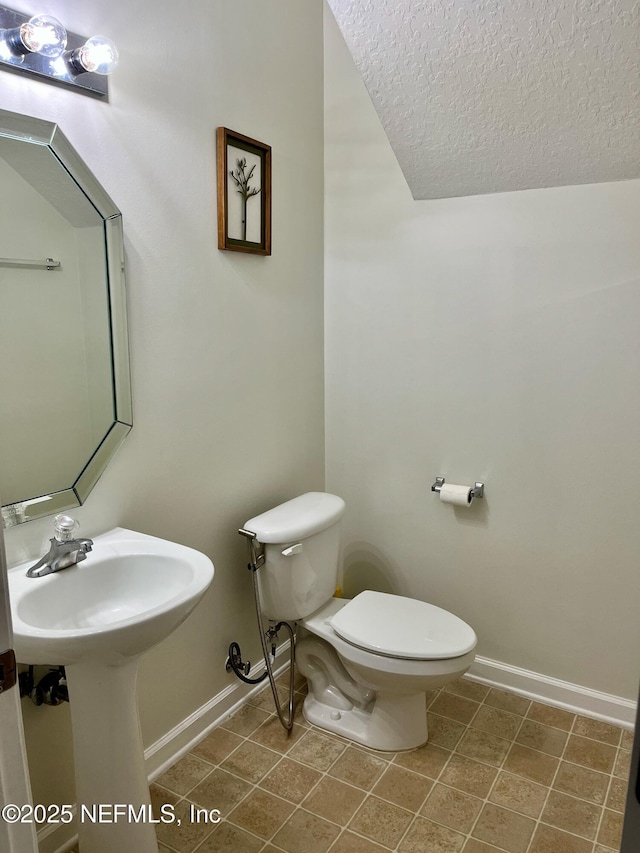 12301 Kernan Forest Blvd Unit 1905, Jacksonville, FL 32225 - half bath with baseboards, toilet, and a textured ceiling