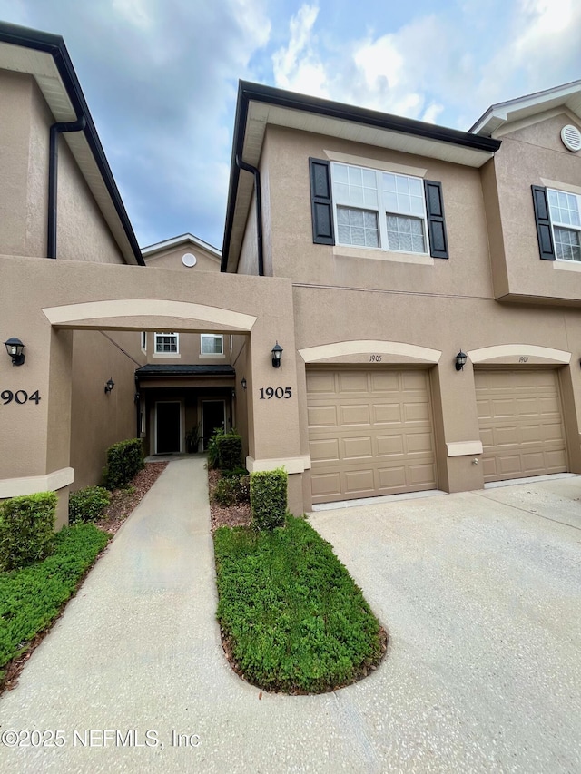 12301 Kernan Forest Blvd Unit 1905, Jacksonville, FL 32225 - townhome / multi-family property with stucco siding, driveway, and an attached garage