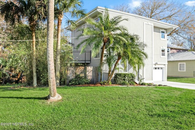 415 Seminole Rd, Atlantic Beach, FL 32233 - view of front of property with a garage, concrete driveway, stucco siding, and a front lawn