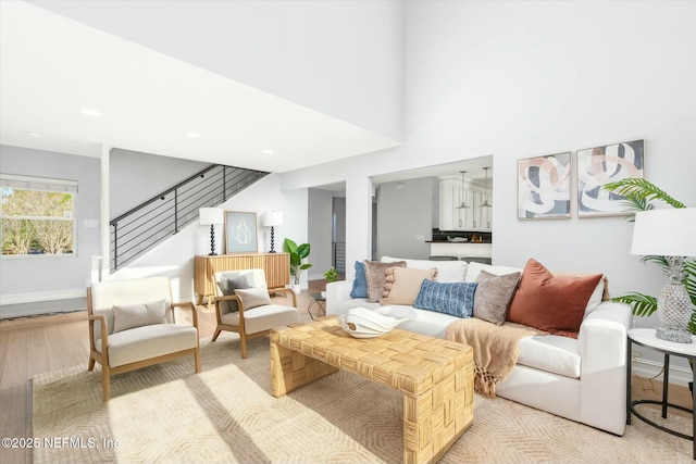 415 Seminole Rd, Atlantic Beach, FL 32233 - living area featuring stairs, baseboards, recessed lighting, light wood-type flooring, and a towering ceiling