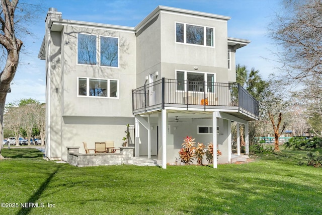 415 Seminole Rd, Atlantic Beach, FL 32233 - rear view of property featuring stucco siding, a lawn, a patio area, a chimney, and a balcony