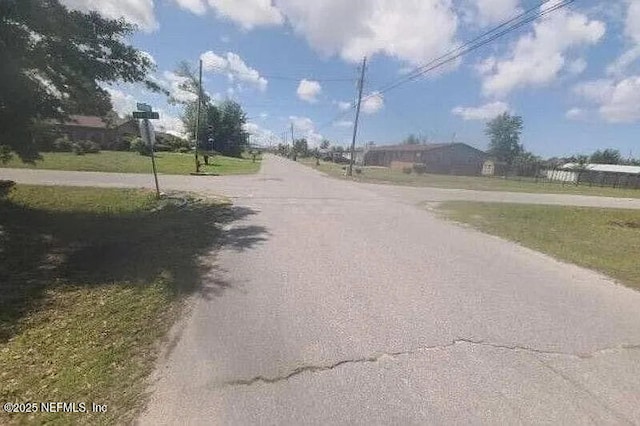1417 Wisconsin Ave, Lynn Haven, FL 32444 - view of asphalt road with traffic signs