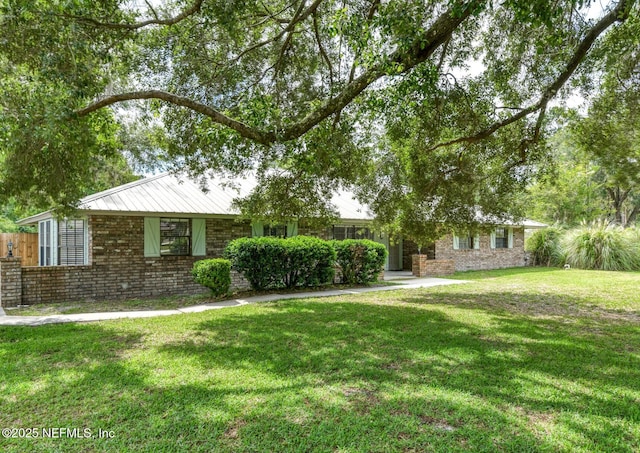 122 Raintree Woods Trl, Palatka, FL 32177 - view of front of house with brick siding and a front lawn