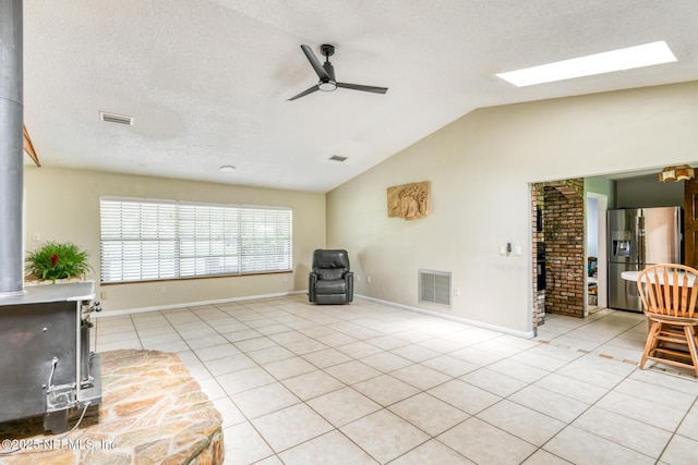 122 Raintree Woods Trl, Palatka, FL 32177 - sitting room with ceiling fan, lofted ceiling, light tile patterned floors, a textured ceiling, and baseboards