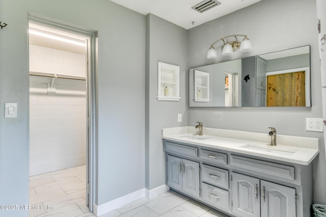 122 Raintree Woods Trl, Palatka, FL 32177 - bathroom featuring marble look tile flooring, double vanity, and baseboards