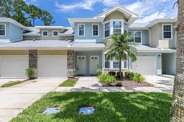 215 Bayberry Cir Unit 605, Saint Augustine, FL 32086 - multi unit property with stucco siding, driveway, a garage, and stone siding