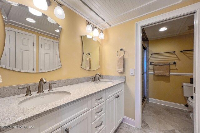 1829 Turtle Dunes Pl Unit 1829, Fernandina Beach, FL 32034 - bathroom with double vanity, toilet, a shower stall, recessed lighting, and baseboards