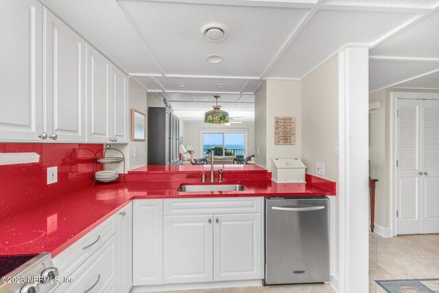 1829 Turtle Dunes Pl Unit 1829, Fernandina Beach, FL 32034 - kitchen featuring dishwasher, a sink, a peninsula, and white cabinets