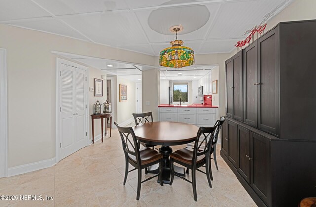 1829 Turtle Dunes Pl Unit 1829, Fernandina Beach, FL 32034 - dining area with baseboards, light tile patterned floors, and coffered ceiling
