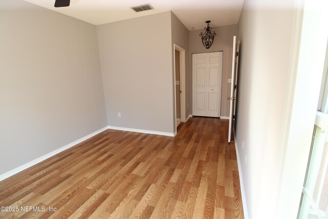 520 Florida Club Blvd Unit 202, Saint Augustine, FL 32084 - spare room featuring light wood-style floors, a chandelier, and baseboards