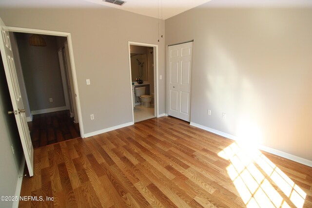 520 Florida Club Blvd Unit 202, Saint Augustine, FL 32084 - unfurnished bedroom featuring wood finished floors, connected bathroom, and baseboards