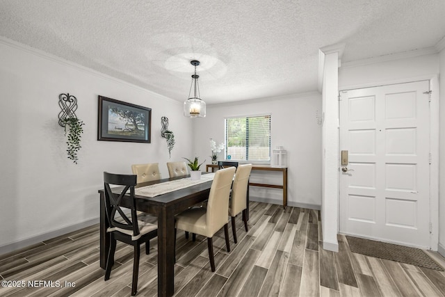 5811 Atlantic Blvd Unit 153, Jacksonville, FL 32207 - dining area featuring ornamental molding, wood finished floors, a textured ceiling, and baseboards