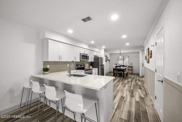 5811 Atlantic Blvd Unit 153, Jacksonville, FL 32207 - kitchen featuring stainless steel appliances, a sink, ornamental molding, recessed lighting, and light countertops
