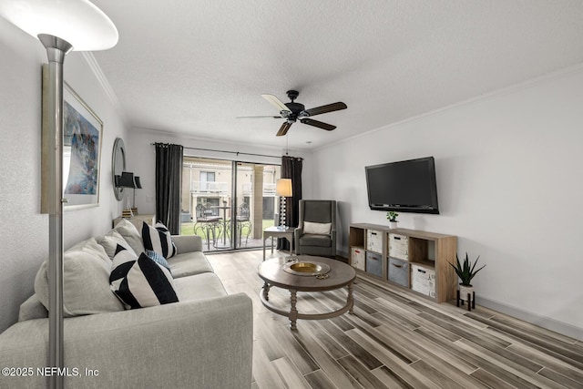 5811 Atlantic Blvd Unit 153, Jacksonville, FL 32207 - living room with crown molding, ceiling fan, wood finished floors, a textured ceiling, and baseboards