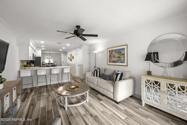 5811 Atlantic Blvd Unit 153, Jacksonville, FL 32207 - living room featuring ornamental molding, ceiling fan, light wood finished floors, a textured ceiling, and recessed lighting