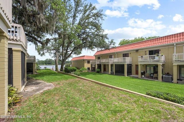 5811 Atlantic Blvd Unit 153, Jacksonville, FL 32207 - view of grassy yard with a water view, cooling unit, and a balcony