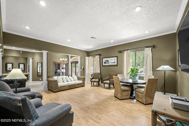 5811 Atlantic Blvd Unit 153, Jacksonville, FL 32207 - living room featuring a chandelier, crown molding, a textured ceiling, recessed lighting, and light wood finished floors