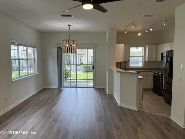 1735 Forest Lake Cir W Unit 2, Jacksonville, FL 32225 - kitchen featuring freestanding refrigerator, stove, white cabinetry, ceiling fan, and wood finished floors