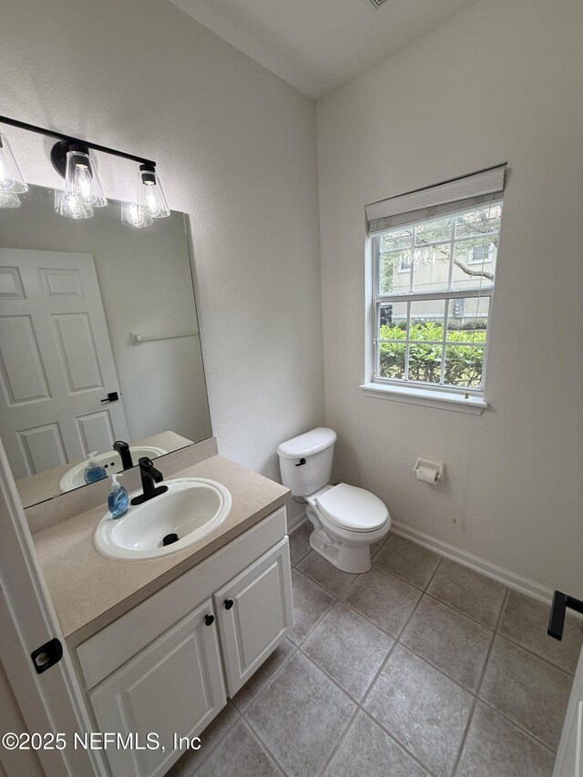 1735 Forest Lake Cir W Unit 2, Jacksonville, FL 32225 - half bath featuring vanity, toilet, tile patterned floors, and baseboards