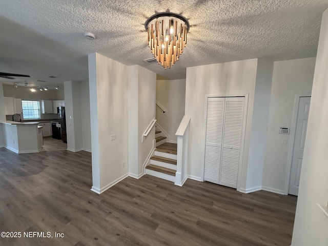 1735 Forest Lake Cir W Unit 2, Jacksonville, FL 32225 - stairway featuring wood finished floors, a chandelier, a textured ceiling, and baseboards