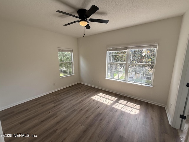 1735 Forest Lake Cir W Unit 2, Jacksonville, FL 32225 - spare room featuring baseboards, dark wood finished floors, ceiling fan, and a textured ceiling