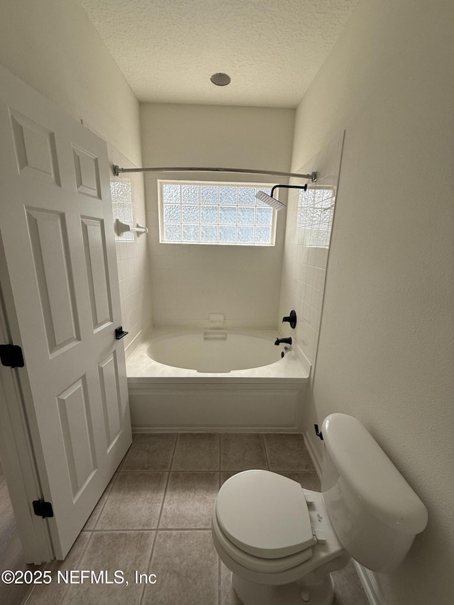 1735 Forest Lake Cir W Unit 2, Jacksonville, FL 32225 - bathroom featuring a textured ceiling, shower / bath combination, toilet, and tile patterned floors