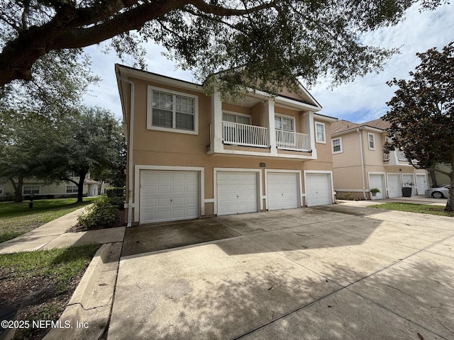 1735 Forest Lake Cir W Unit 2, Jacksonville, FL 32225 - townhome / multi-family property featuring stucco siding, an attached garage, and concrete driveway