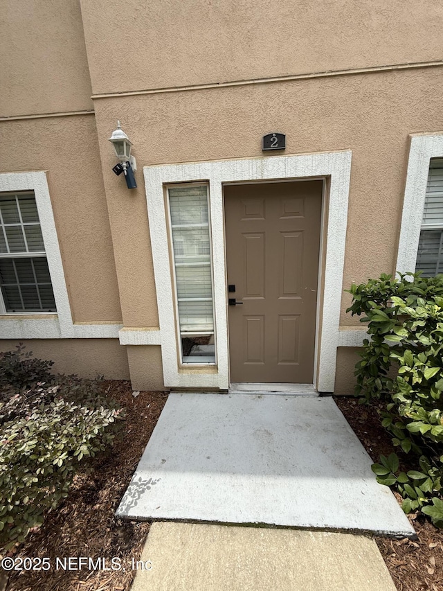 1735 Forest Lake Cir W Unit 2, Jacksonville, FL 32225 - view of exterior entry with stucco siding