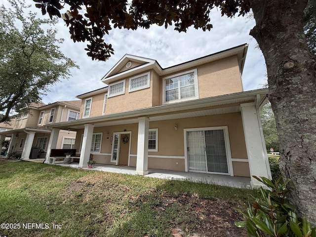1735 Forest Lake Cir W Unit 2, Jacksonville, FL 32225 - view of front facade featuring stucco siding and a front lawn