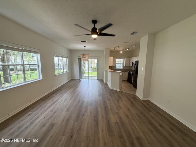1735 Forest Lake Cir W Unit 2, Jacksonville, FL 32225 - unfurnished living room featuring a chandelier, a ceiling fan, dark wood-style flooring, a textured ceiling, and baseboards