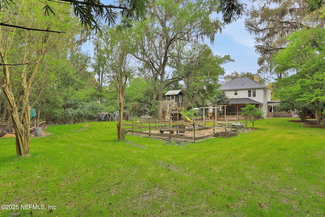 7265 Beach Rd, Elkton, FL 32033 - view of green lawn featuring a garden and a playground