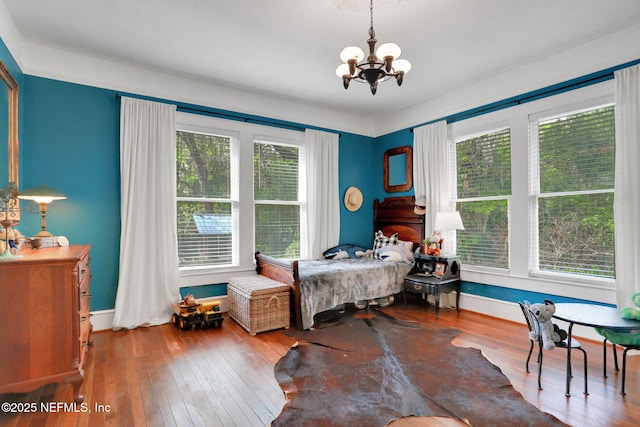 7265 Beach Rd, Elkton, FL 32033 - bedroom featuring a chandelier, hardwood / wood-style flooring, and baseboards