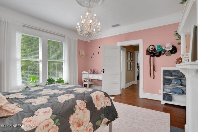 7265 Beach Rd, Elkton, FL 32033 - bedroom with wood finished floors, a chandelier, and baseboards