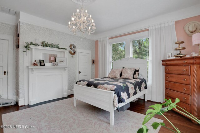 7265 Beach Rd, Elkton, FL 32033 - bedroom with wood finished floors and a chandelier