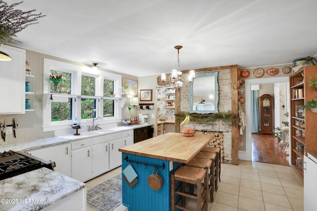 7265 Beach Rd, Elkton, FL 32033 - kitchen with wood counters, open shelves, light tile patterned floors, and white cabinets