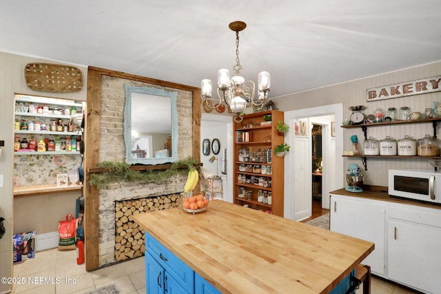 7265 Beach Rd, Elkton, FL 32033 - dining space with light tile patterned floors and a chandelier