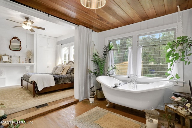 7265 Beach Rd, Elkton, FL 32033 - bathroom with wood finished floors, a freestanding tub, wooden ceiling, and a ceiling fan