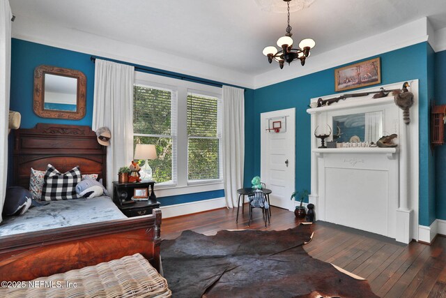 7265 Beach Rd, Elkton, FL 32033 - bedroom featuring a chandelier, wood finished floors, and baseboards