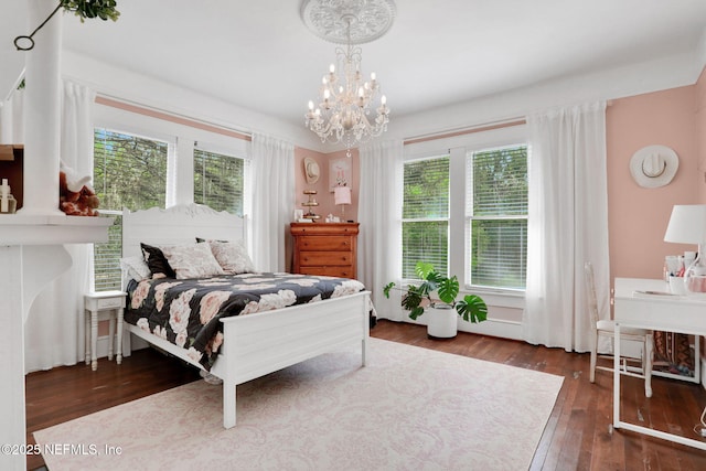 7265 Beach Rd, Elkton, FL 32033 - bedroom featuring multiple windows, wood-type flooring, and a chandelier