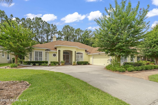 2305 Range Crescent Ct, Fleming Island, FL 32003 - view of front facade with an attached garage, a chimney, a front lawn, driveway, and stucco siding