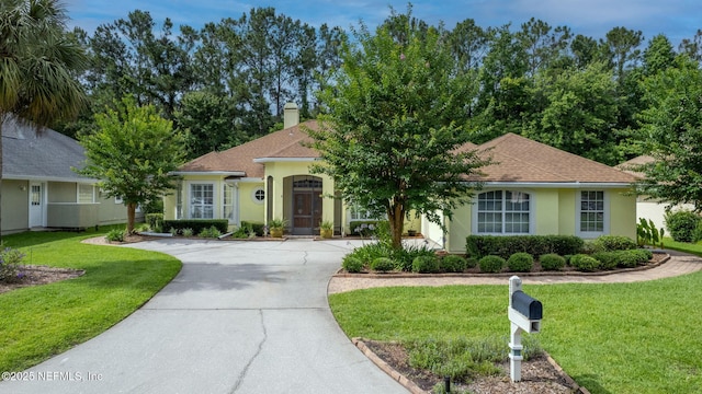 2305 Range Crescent Ct, Fleming Island, FL 32003 - view of front facade featuring stucco siding, concrete driveway, a front lawn, and a chimney
