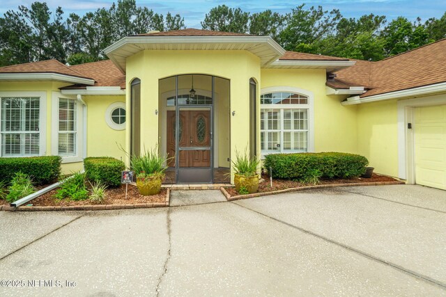 2305 Range Crescent Ct, Fleming Island, FL 32003 - property entrance with stucco siding and a shingled roof