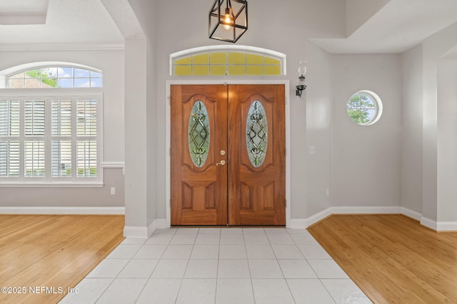 2305 Range Crescent Ct, Fleming Island, FL 32003 - foyer with healthy amount of natural light, wood finished floors, and baseboards