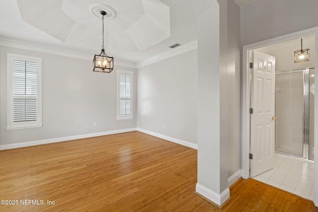 2305 Range Crescent Ct, Fleming Island, FL 32003 - spare room with light wood-style flooring, ornamental molding, a chandelier, baseboards, and a raised ceiling