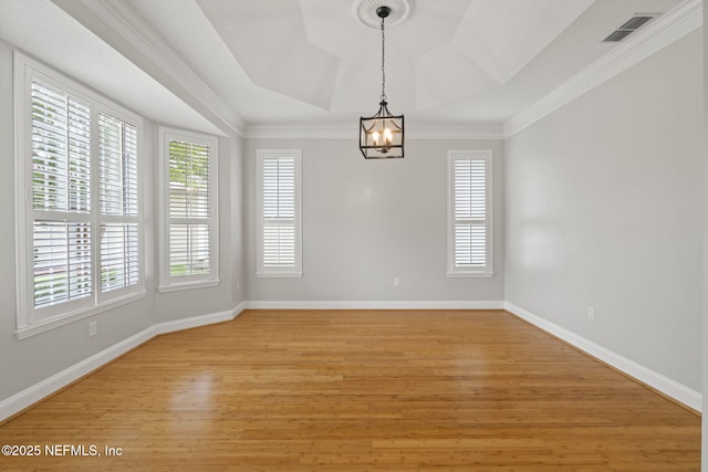 2305 Range Crescent Ct, Fleming Island, FL 32003 - spare room with a chandelier, light wood-style floors, baseboards, crown molding, and a raised ceiling