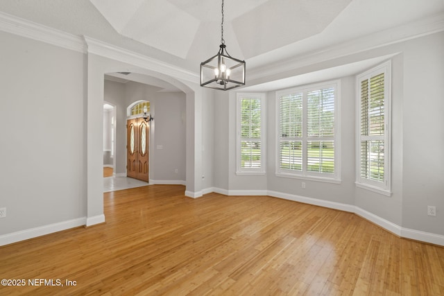 2305 Range Crescent Ct, Fleming Island, FL 32003 - empty room with a chandelier, arched walkways, light wood finished floors, baseboards, and ornamental molding